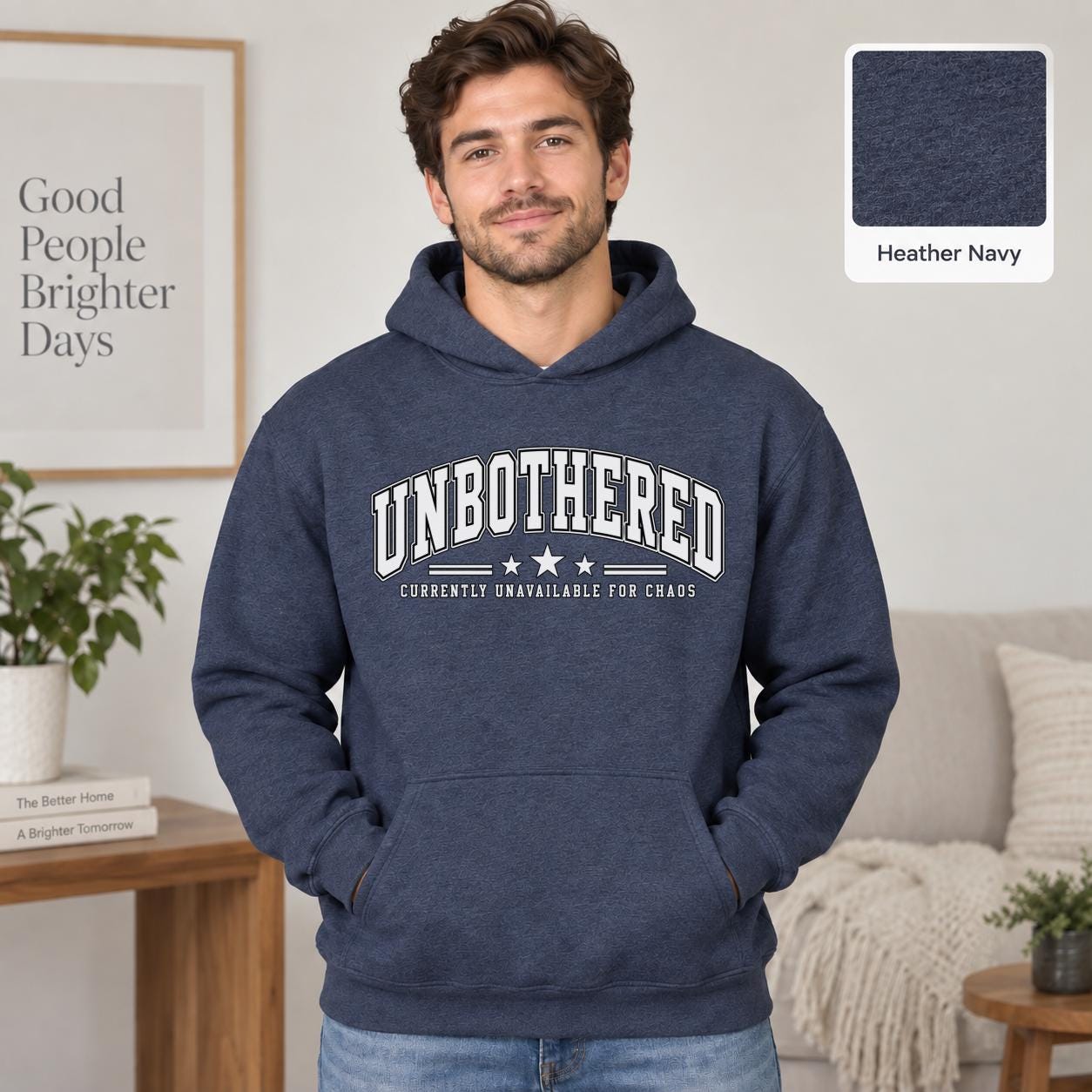 Male model wearing a heather navy Gildan 18500 hoodie with a clean white Unbothered graphic and the phrase Currently Unavailable for Chaos, styled for a minimalist neutral aesthetic.