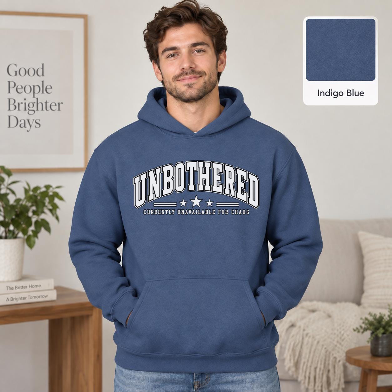 Male model wearing a indigo blue Gildan 18500 hoodie with a clean white Unbothered graphic and the phrase Currently Unavailable for Chaos, styled for a minimalist neutral aesthetic.