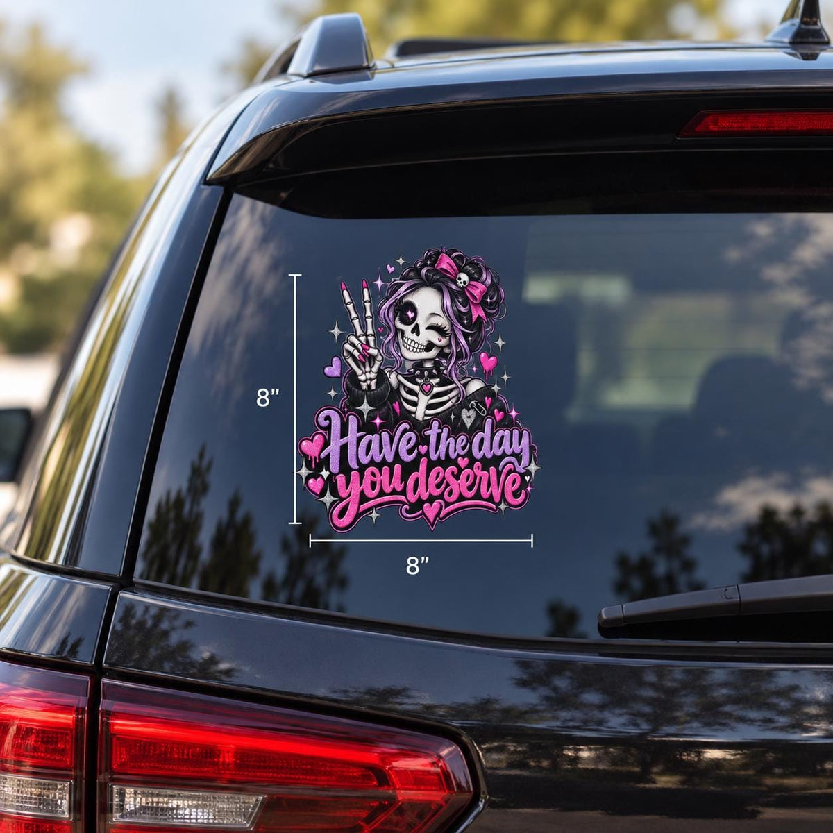 Cute goth skeleton girl Have the Day You Deserve decal shown on an SUV window with pink hearts, sparkles, and bold script text.