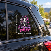 Have the Day You Deserve car window decal featuring a smiling skeleton girl with pink bow, peace sign, hearts, and pastel goth details.