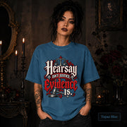 Hearsay Isn’t Justice Evidence Is topaz blue T-shirt featuring red and white gothic lettering, scales of justice, and a judge’s gavel.