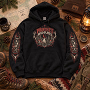 Flat lay of a black Protect Wild Places hoodie with front chest artwork and matching sleeve graphics, styled with hiking boots, map, lantern, and outdoor accessories.