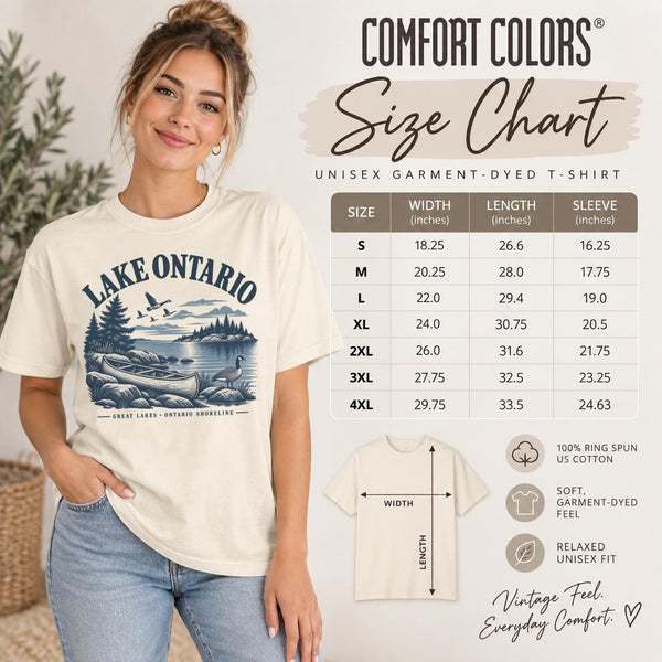 Size chart Comfort Colors T-shirt featuring a vintage Lake Ontario shoreline graphic with canoe, pine trees, rocky shore, Canada geese, water, and Great Lakes Ontario Shoreline text.