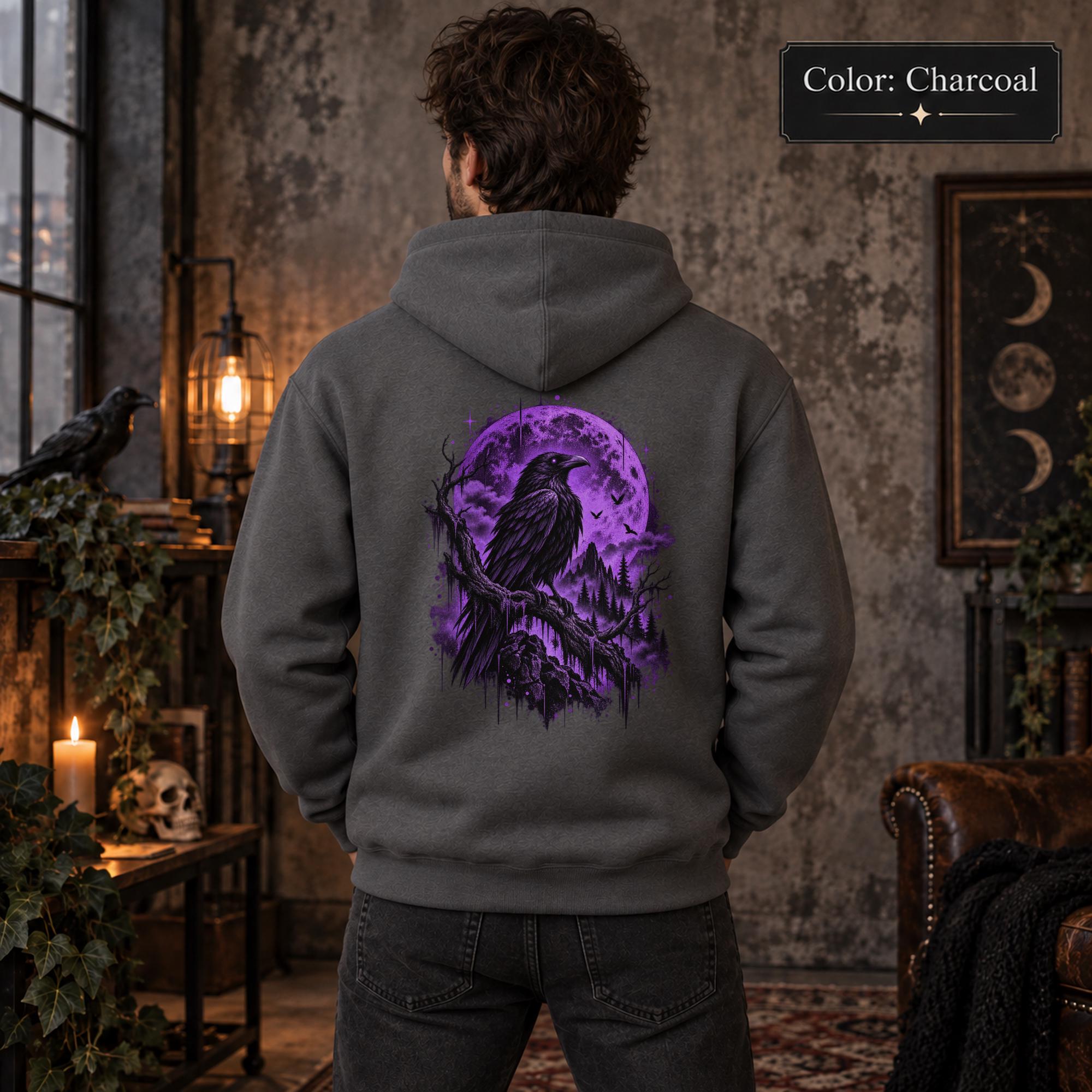 Charcoal unisex hoodie displayed from the back with a vivid purple raven and moon graphic, set against a gothic woodland scene with lanterns and dark forest styling.