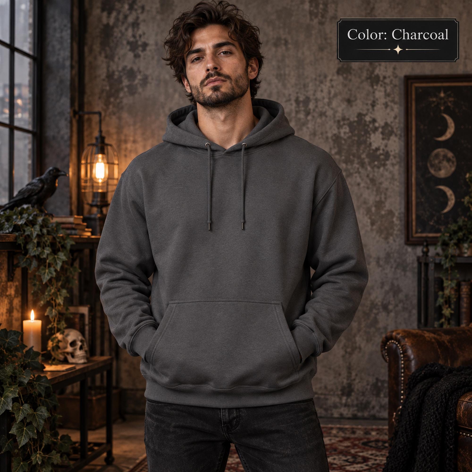 Charcoal unisex hoodie shown from the front, featuring a large purple raven perched on the back against a glowing violet moon, surrounded by mountains, pine trees, mist, and celestial details.
