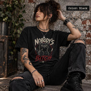 Black Comfort Colors 1717 T-shirt mockup with Nobody’s Bitch black cat graphic, grunge lettering, red accents, and alternative gothic style.