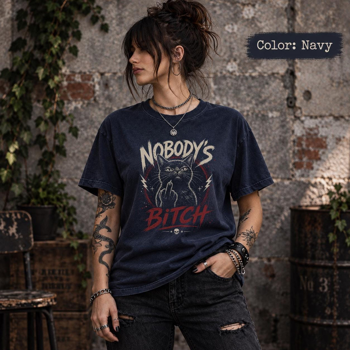 Navy Comfort Colors 1717 tee featuring Nobody’s Bitch cat artwork with middle finger gesture, distressed cream text, red details, and edgy punk aesthetic.
