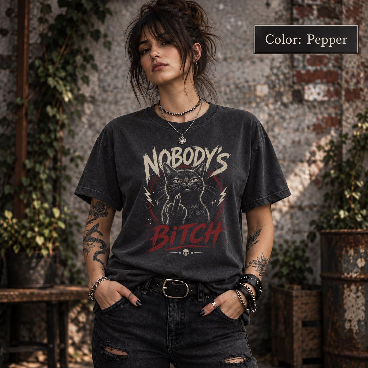 Pepper Comfort Colors 1717 T-shirt displaying Nobody’s Bitch cat design with vintage distressed print, red lettering, and rebellious gothic look.