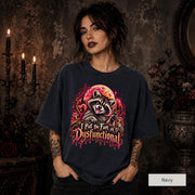 Female model wearing a navy Comfort Colors 1717 tee featuring a colorful raccoon beneath a glowing moon with mushrooms and the phrase “I Put the Fun in Dysfunctional.”