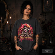 Female model wearing a pepper Comfort Colors 1717 tee featuring a colorful raccoon beneath a glowing moon with mushrooms and the phrase “I Put the Fun in Dysfunctional.”