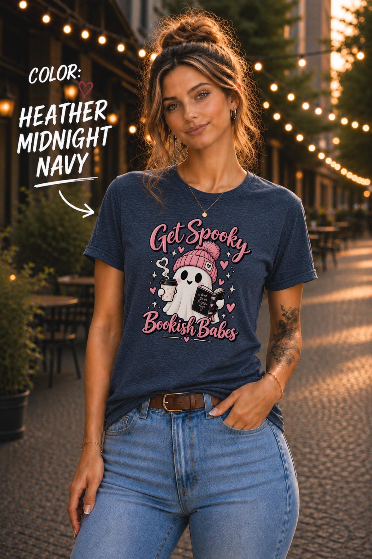 Get Spooky Bookish Babes T-shirt featuring a cute ghost in a pink beanie holding a book and coffee, with hearts and stars on a dark navy shirt.