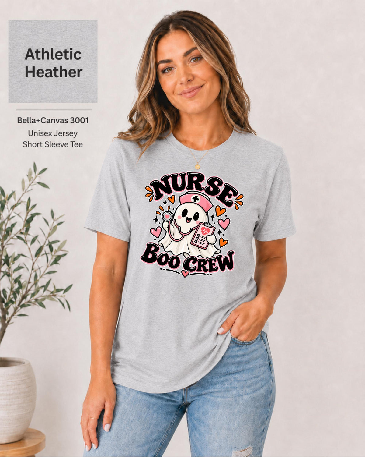 Nurse Boo Crew T-shirt in Athletic Heather featuring a cute ghost nurse with a pink cap, stethoscope, clipboard, hearts, and playful Halloween accents.