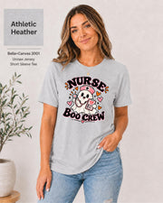 Nurse Boo Crew T-shirt in Athletic Heather featuring a cute ghost nurse with a pink cap, stethoscope, clipboard, hearts, and playful Halloween accents.