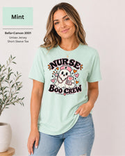 Nurse Boo Crew T-shirt in Mint featuring a cute ghost nurse with a pink cap, stethoscope, clipboard, hearts, and playful Halloween accents.