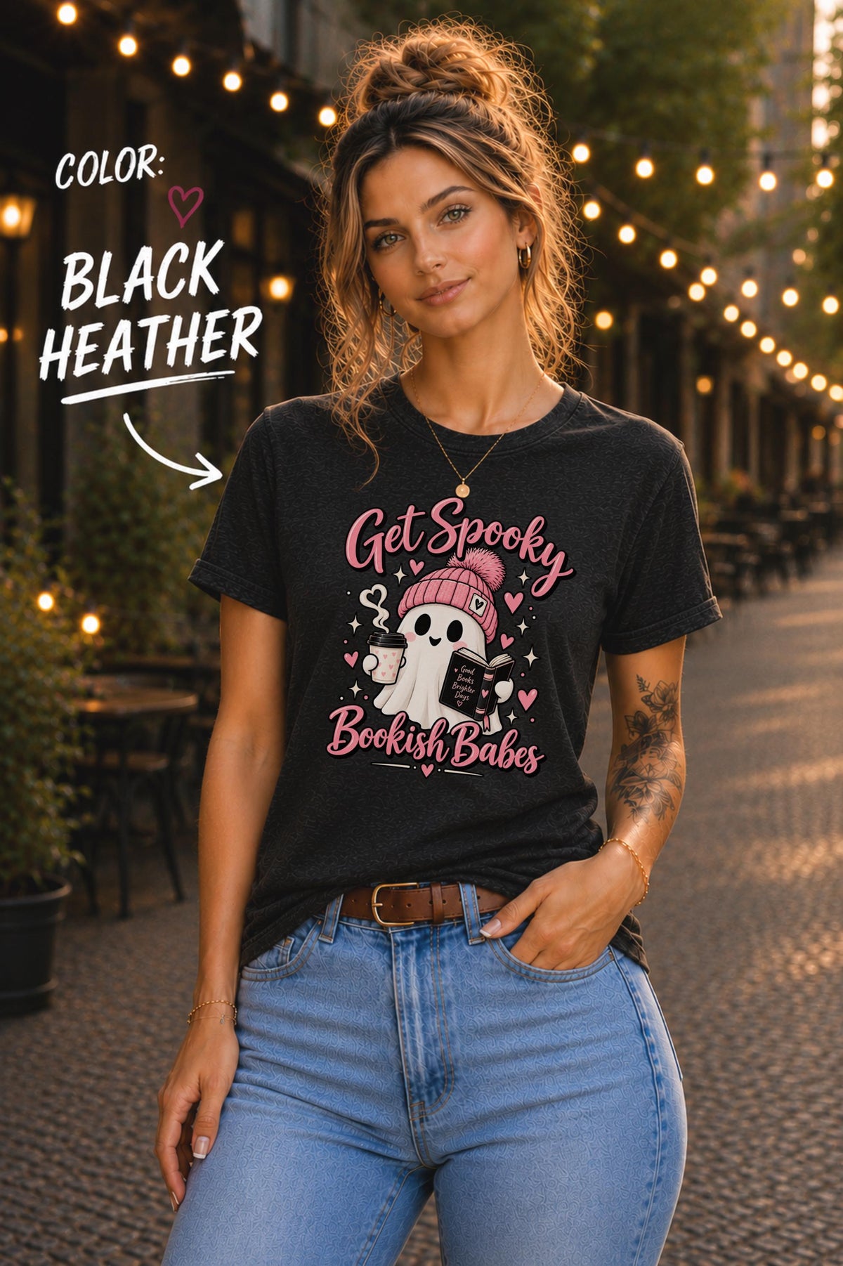 Get Spooky Bookish Babes T-shirt featuring a cute ghost in a pink beanie holding a book and coffee, with hearts and stars on a black heather shirt.
