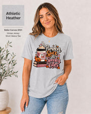 Bella+Canvas 3001 Athletic Heather  unisex T-shirt featuring a “Pumpkin Spice & Spooky Vibes” design with a ghost reading, fall coffee, stacked books, jack-o’-lantern, hearts, and autumn leaves.