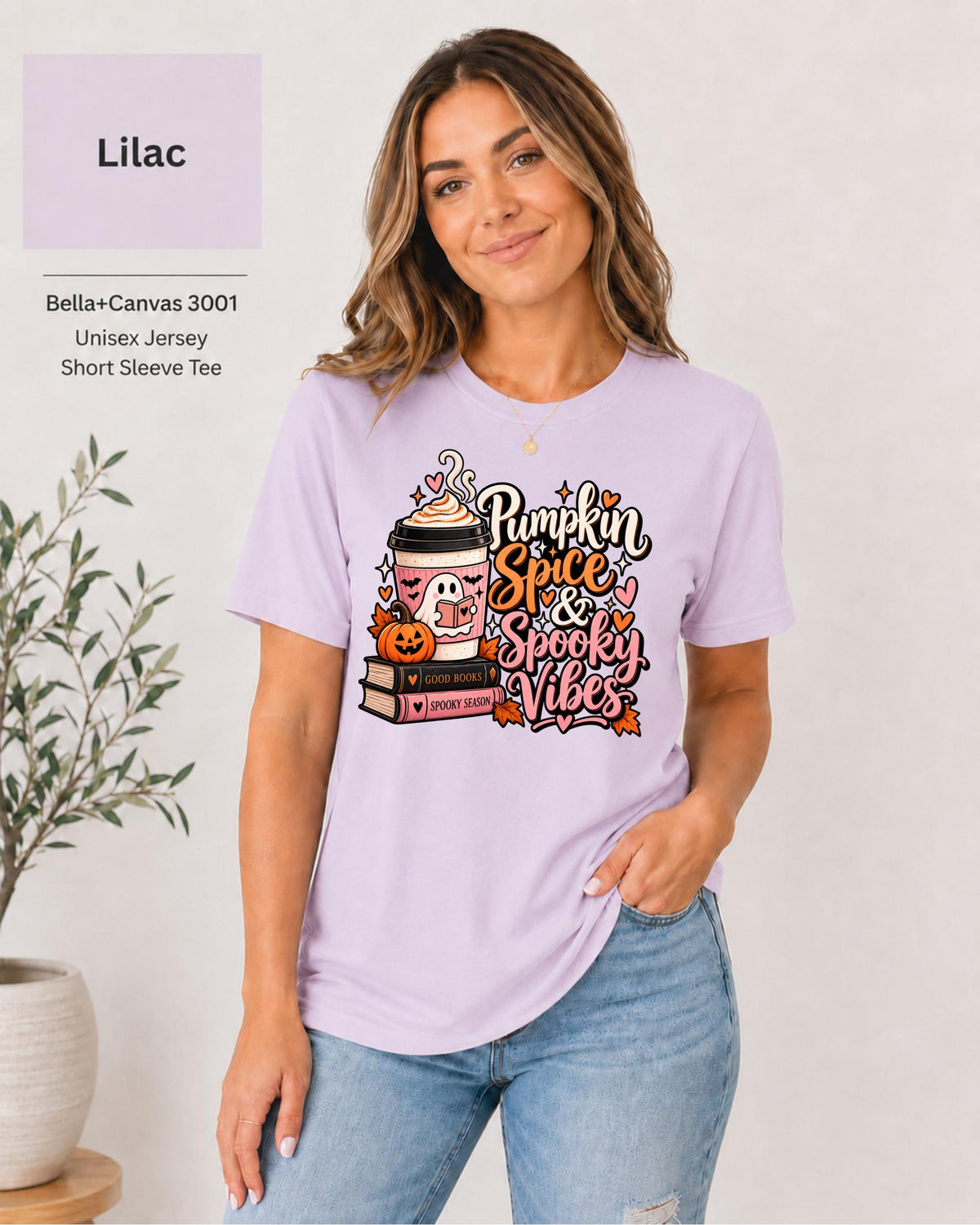 Bella+Canvas 3001 Lilac unisex T-shirt featuring a “Pumpkin Spice & Spooky Vibes” design with a ghost reading, fall coffee, stacked books, jack-o’-lantern, hearts, and autumn leaves.