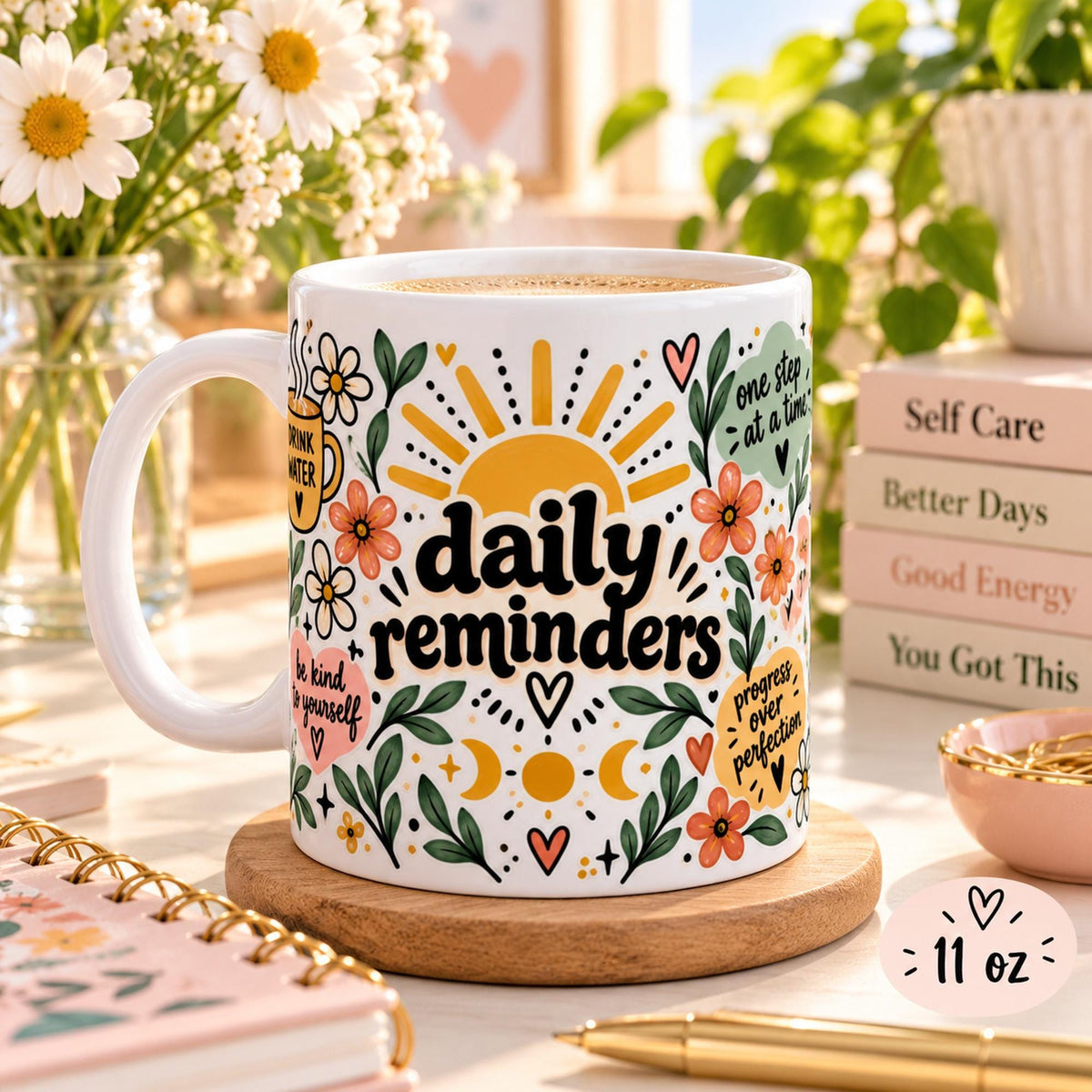 Daily Reminders ceramic mugs in 11 oz featuring colorful floral, sunshine, heart, and moon artwork with positive self-care phrases including drink water, be kind to yourself, you are enough, one step at a time, and progress over perfection.