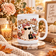 15 oz Boo-Jee coffee mug mockup with glam ghost artwork in a cozy rustic autumn setup with simple decor, warm lighting, and size label.