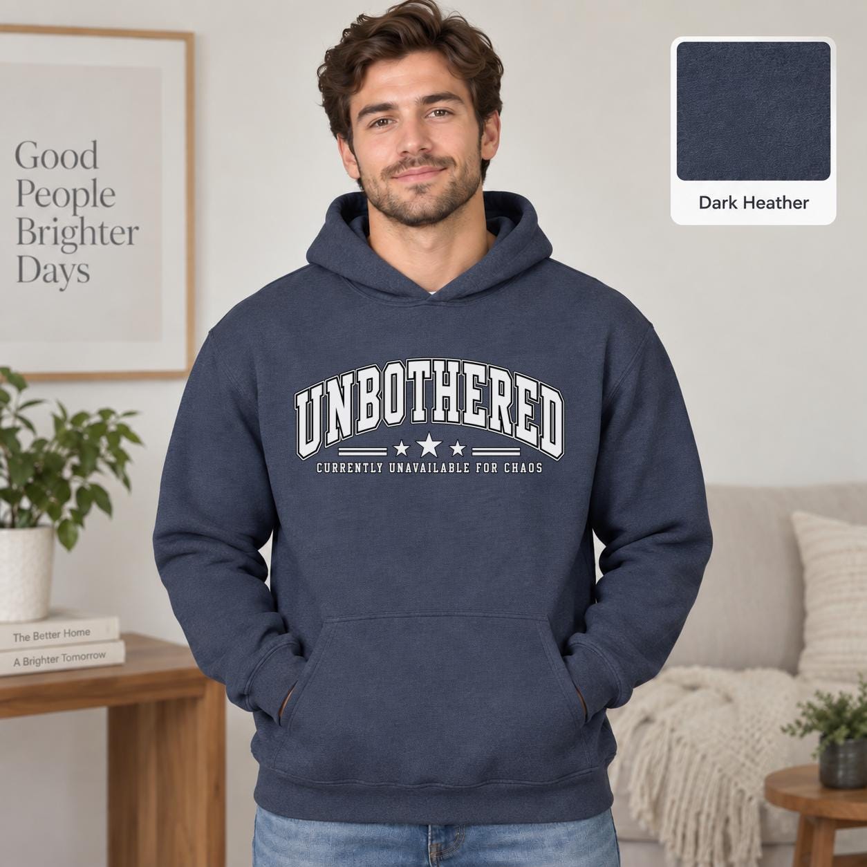 Male model wearing a dark heather Gildan 18500 hoodie with a clean white Unbothered graphic and the phrase Currently Unavailable for Chaos, styled for a minimalist neutral aesthetic.