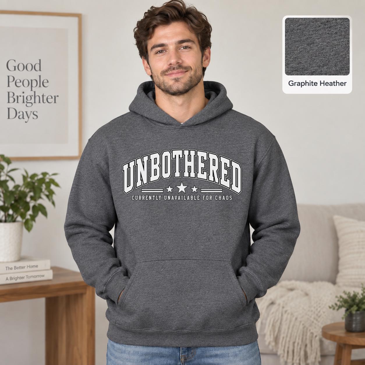 Male model wearing a graphite heather Gildan 18500 hoodie with a clean white Unbothered graphic and the phrase Currently Unavailable for Chaos, styled for a minimalist neutral aesthetic.