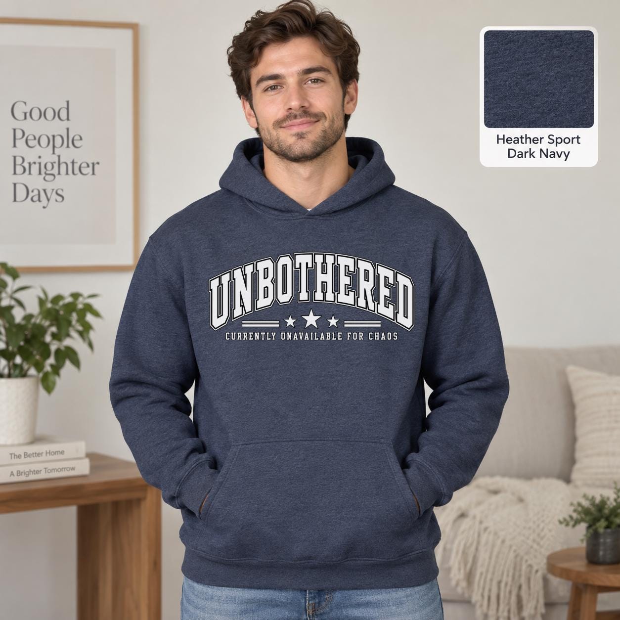 Male model wearing a heather sport dark navy Gildan 18500 hoodie with a clean white Unbothered graphic and the phrase Currently Unavailable for Chaos, styled for a minimalist neutral aesthetic.