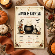 Vintage A Baby Is Brewing Halloween baby shower invitation with gothic pumpkins, celestial accents and editable Canva event details.