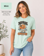 Woman wearing an Mint Bella+Canvas 3001 unisex t-shirt featuring a cute pumpkin nurse graphic and the phrase “Nurse Cute But Clinically Tired.”