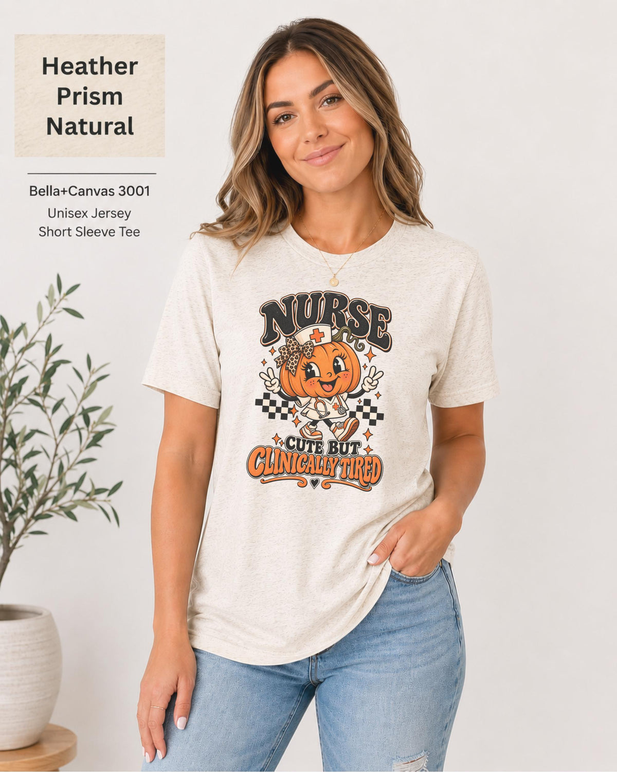 Woman wearing an Heather Prism Natural Bella+Canvas 3001 unisex t-shirt featuring a cute pumpkin nurse graphic and the phrase “Nurse Cute But Clinically Tired.”
