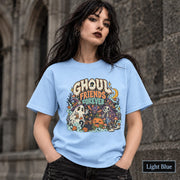 Light Blue unisex T-shirt featuring a colorful “Ghoul Friends Forever” Halloween graphic with a ghost, black cat, pumpkin, witchy skeleton, bats, mushrooms, crescent moon, and autumn accents.