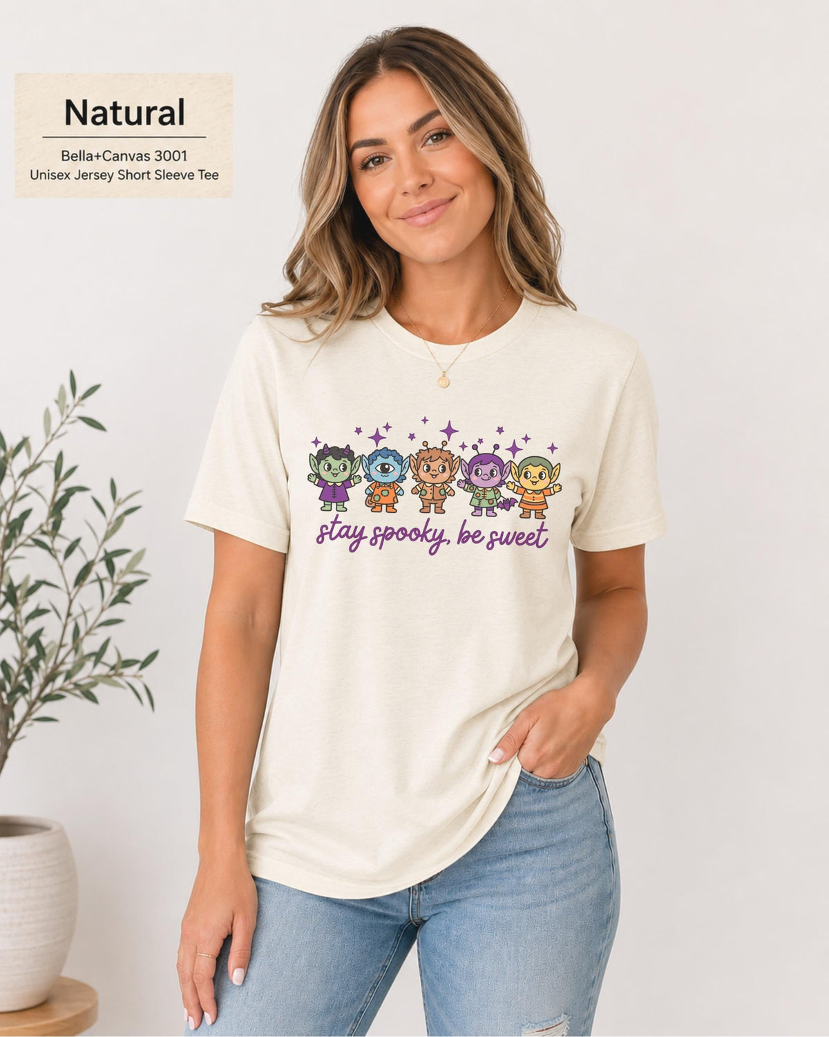 Bella+Canvas 3001 Natural unisex T-shirt featuring five cute Halloween-inspired characters with stars and the phrase “Stay Spooky, Be Sweet” in a small centered chest design.