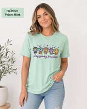 Bella+Canvas 3001 Heather Prism Mint unisex T-shirt featuring five cute Halloween-inspired characters with stars and the phrase “Stay Spooky, Be Sweet” in a small centered chest design.