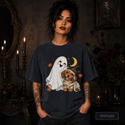 Midnight unisex T-shirt featuring a smiling white ghost beside a mummy-wrapped puppy wearing a witch hat, with a crescent moon, stars, and orange autumn leaves.