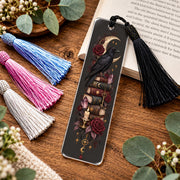 Gothic raven acrylic bookmark with black, white, pink, blue tassel featuring crescent moon, red roses, antique books, crystals, candle and vintage key.