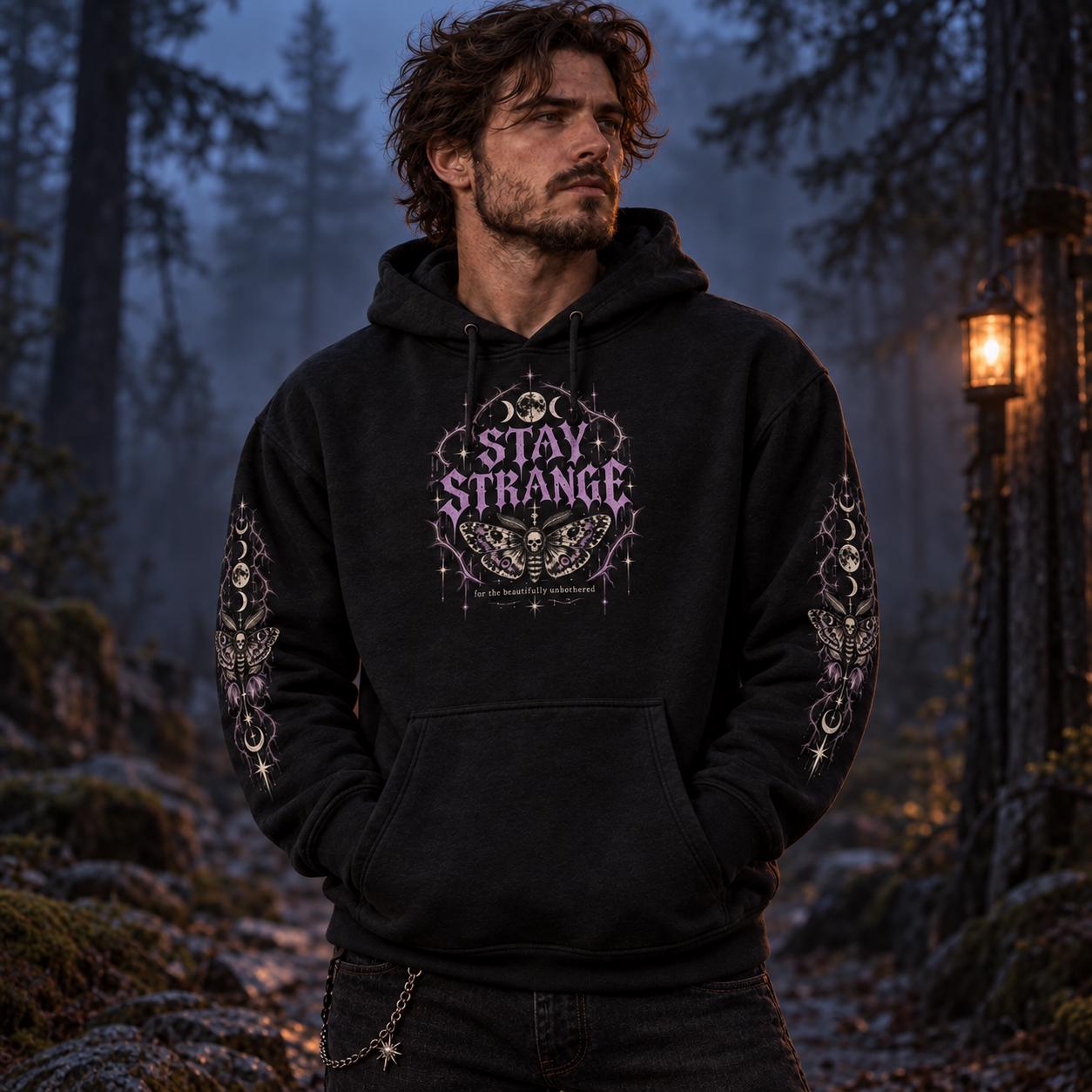Black  Stay Strange Social Club heavyweight hoodie featuring purple gothic lettering, death’s-head moth artwork, moon phases, thorn details, and matching celestial sleeve designs.