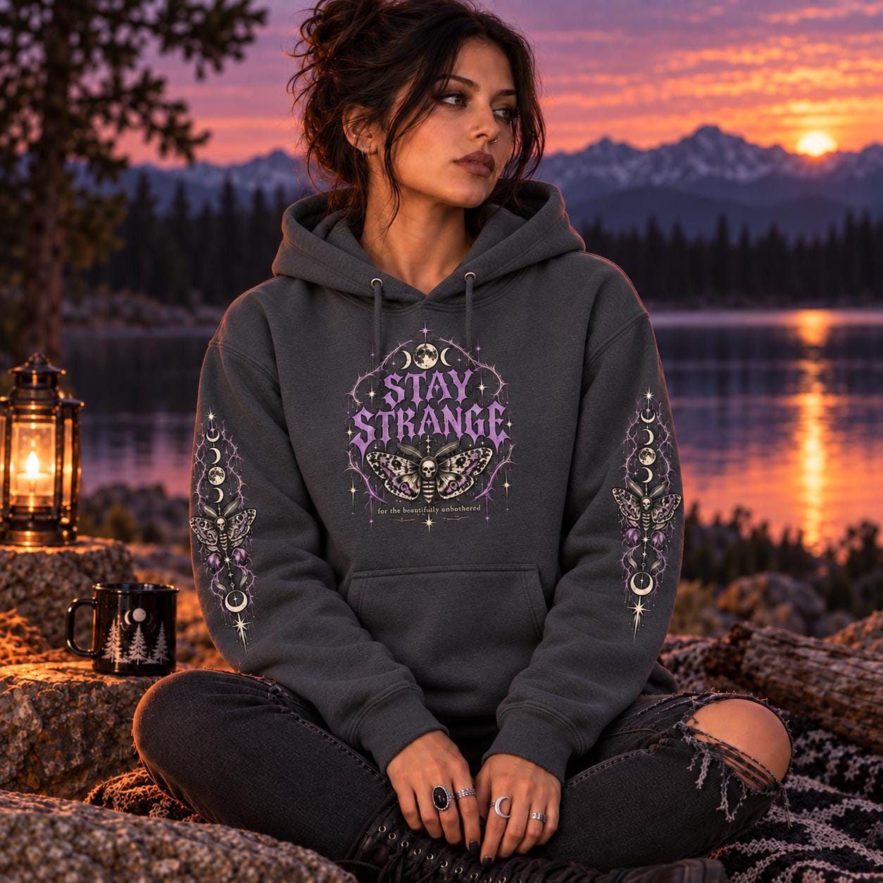 Charcoal Stay Strange Social Club heavyweight hoodie featuring purple gothic lettering, death’s-head moth artwork, moon phases, thorn details, and matching celestial sleeve designs.