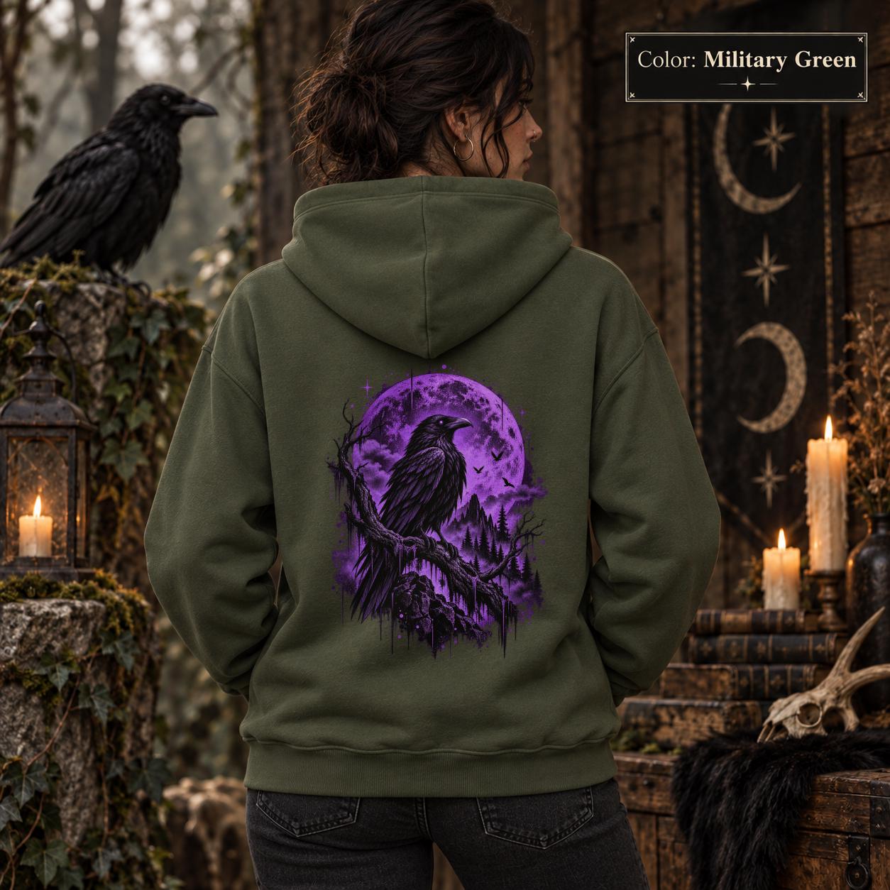 Military Green unisex hoodie displayed from the back with a vivid purple raven and moon graphic, set against a gothic woodland scene with lanterns and dark forest styling.