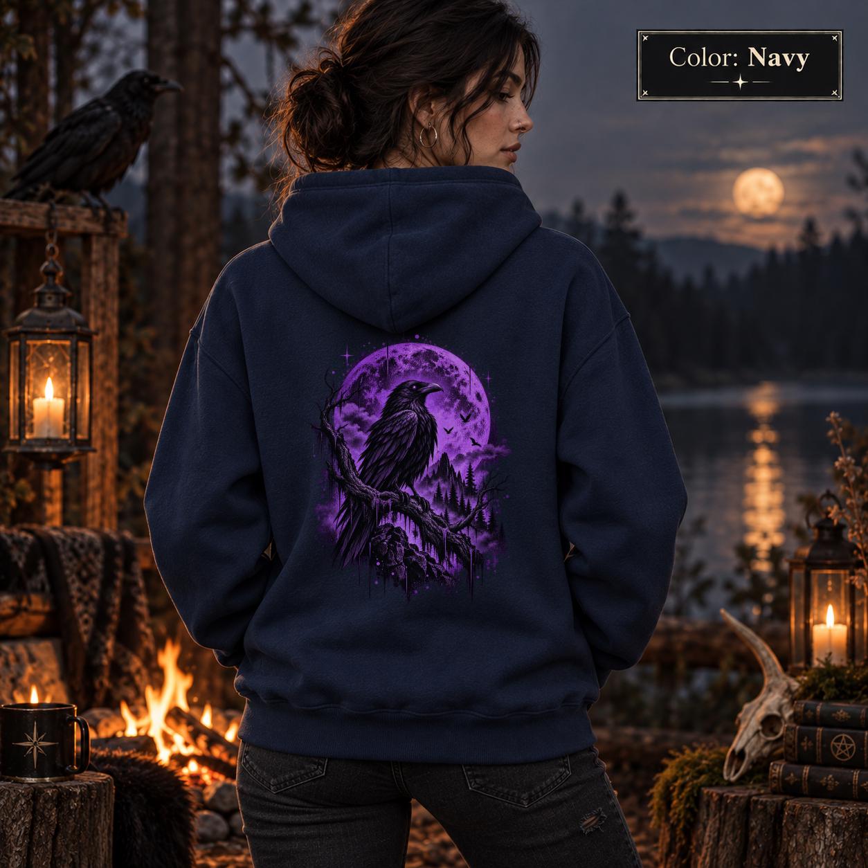 Navy unisex hoodie displayed from the back with a vivid purple raven and moon graphic, set against a gothic woodland scene with lanterns and dark forest styling.