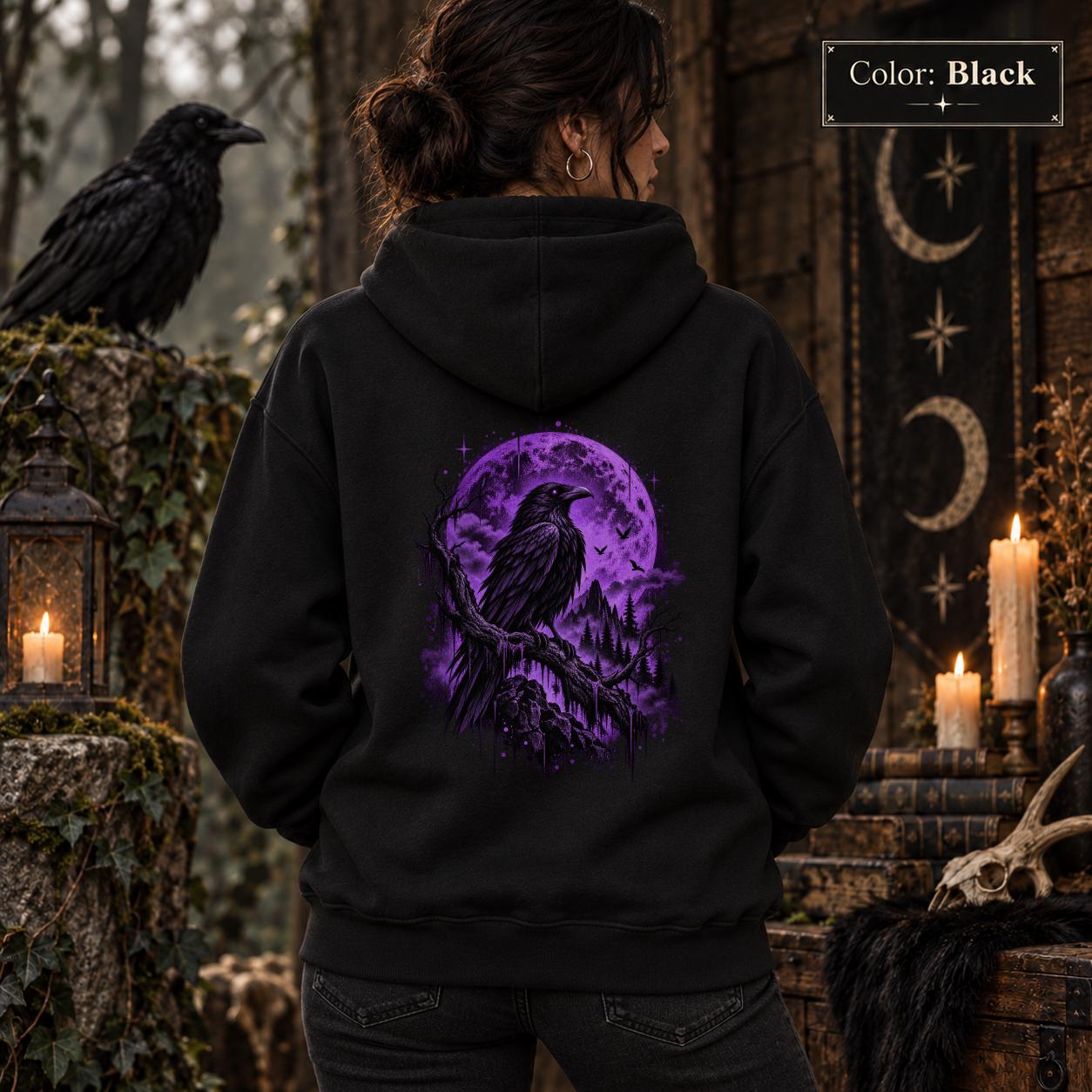 Black unisex hoodie shown from the back with a large purple raven perched before a glowing violet moon, surrounded by mountains, pine trees, mist, and celestial details.