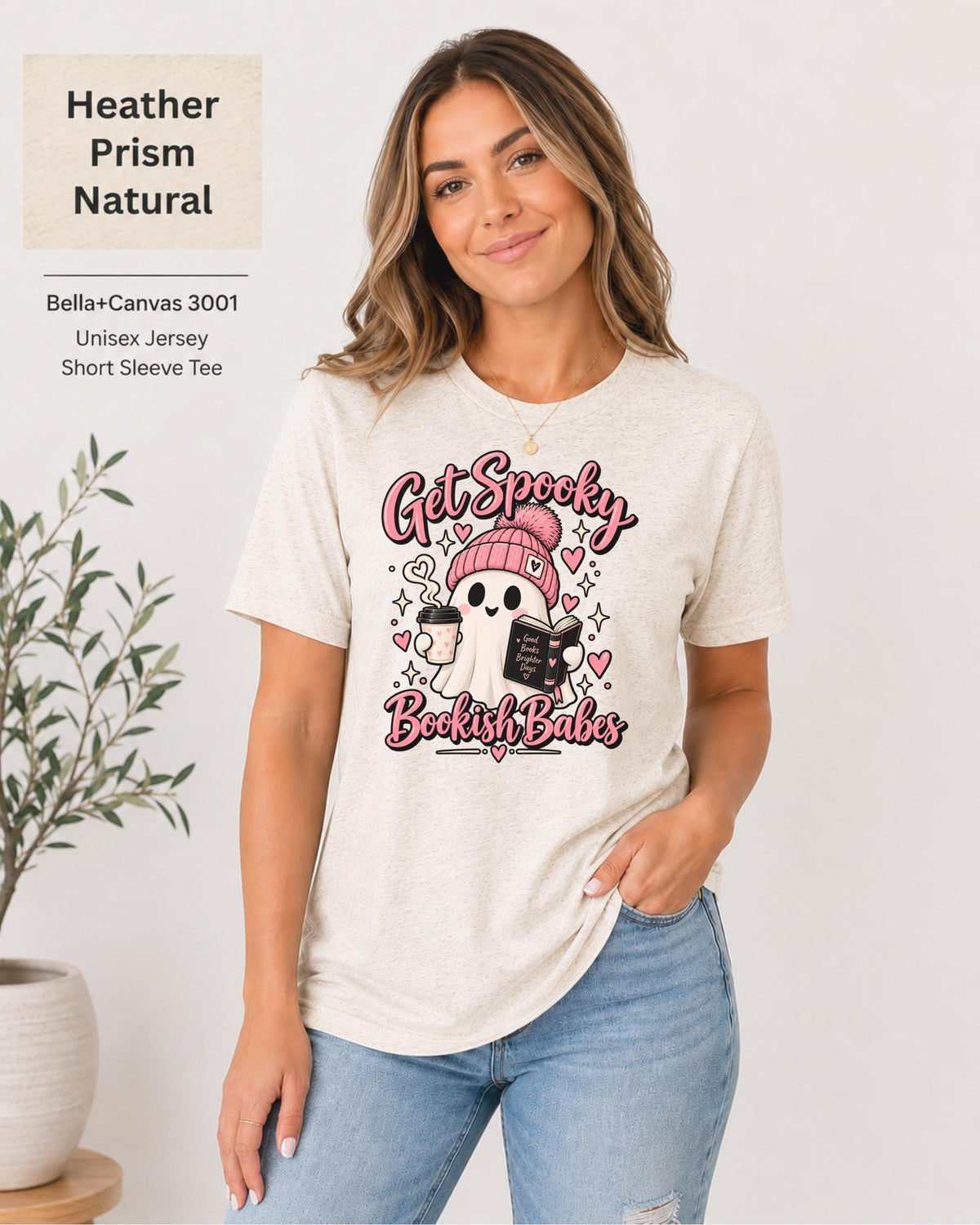 Bella+Canvas 3001 Heather Prism Natural unisex T-shirt featuring a cute ghost in a pink beanie holding coffee and a book with “Get Spooky Bookish Babes” lettering, hearts, and stars.