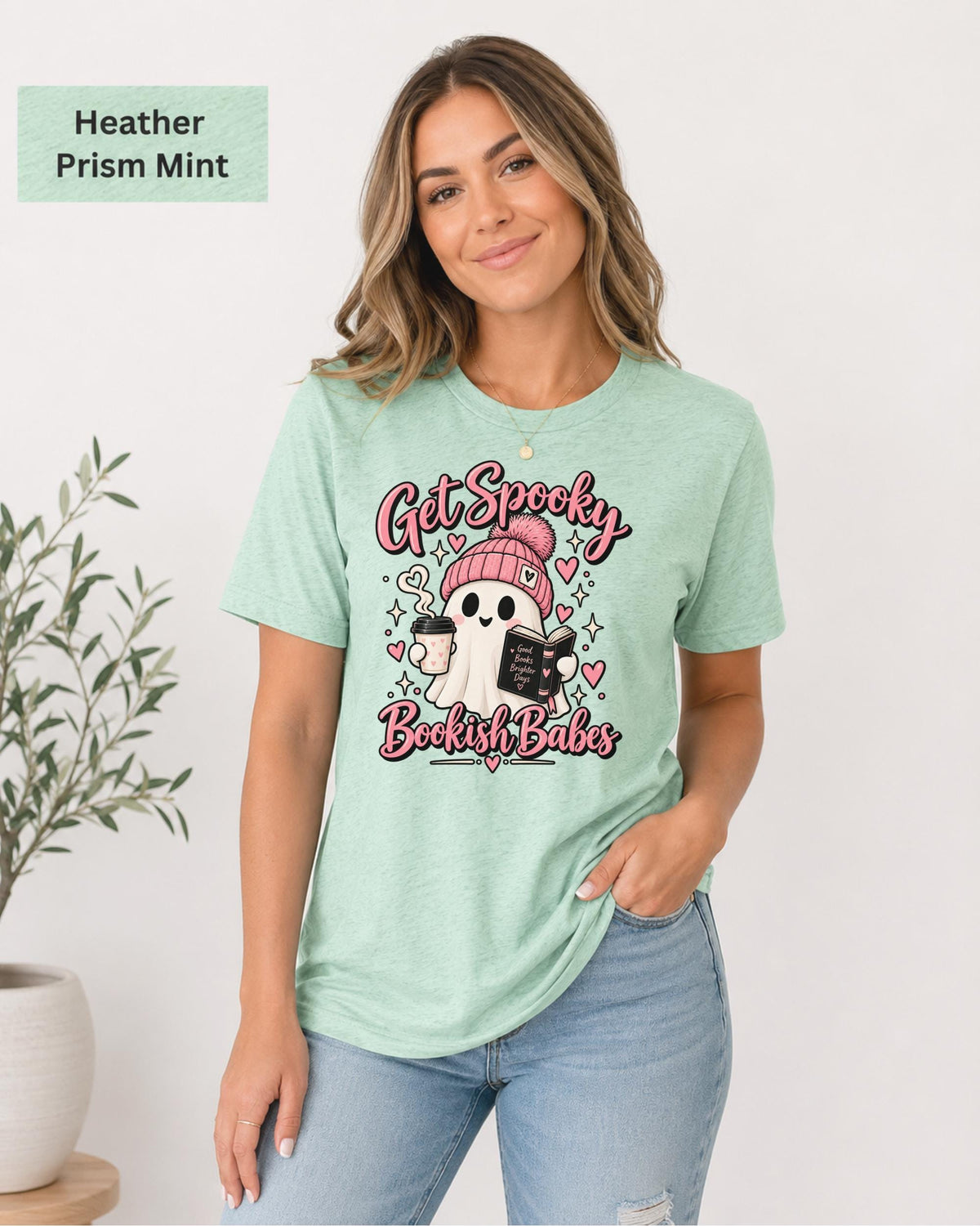 Bella+Canvas 3001 Heather Prism Mint unisex T-shirt featuring a cute ghost in a pink beanie holding coffee and a book with “Get Spooky Bookish Babes” lettering, hearts, and stars.