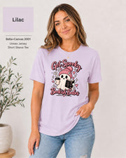 Bella+Canvas 3001 Lilac unisex T-shirt featuring a cute ghost in a pink beanie holding coffee and a book with “Get Spooky Bookish Babes” lettering, hearts, and stars.