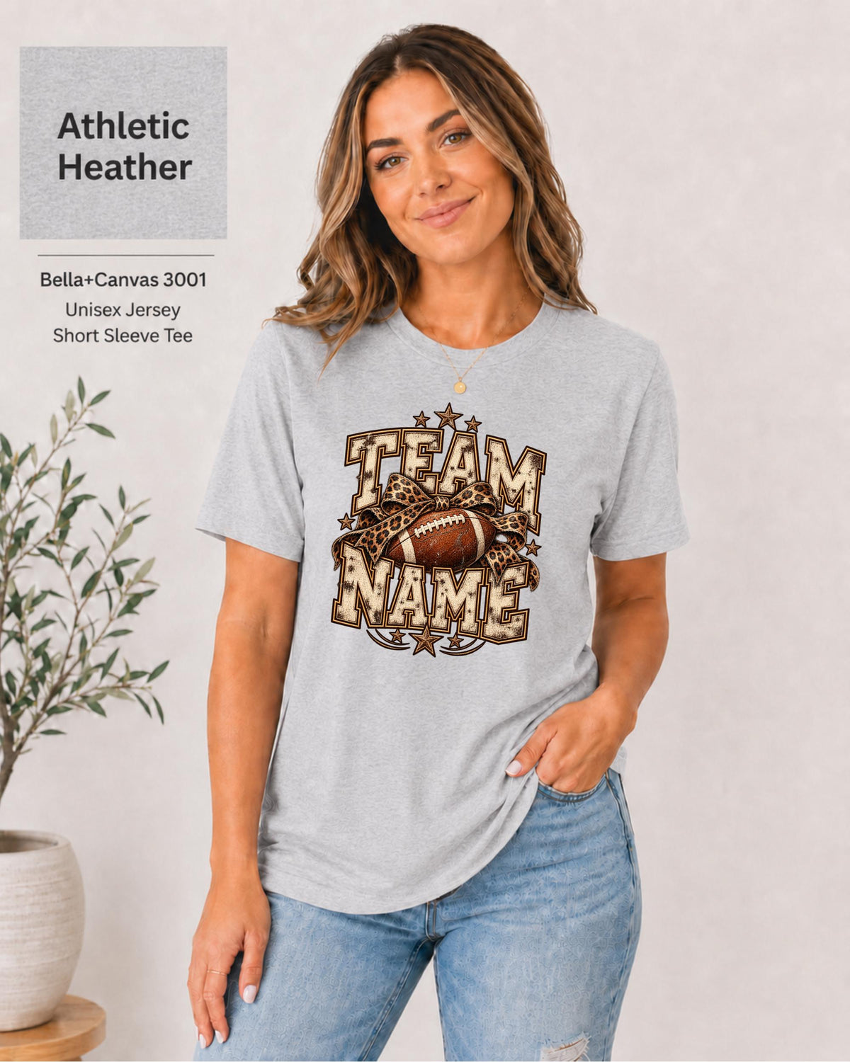 Athletic Heather Bella+Canvas 3001 unisex T-shirt featuring a customizable vintage football graphic with bold “Team Name” lettering, leopard-print bow, stars, and distressed varsity details.