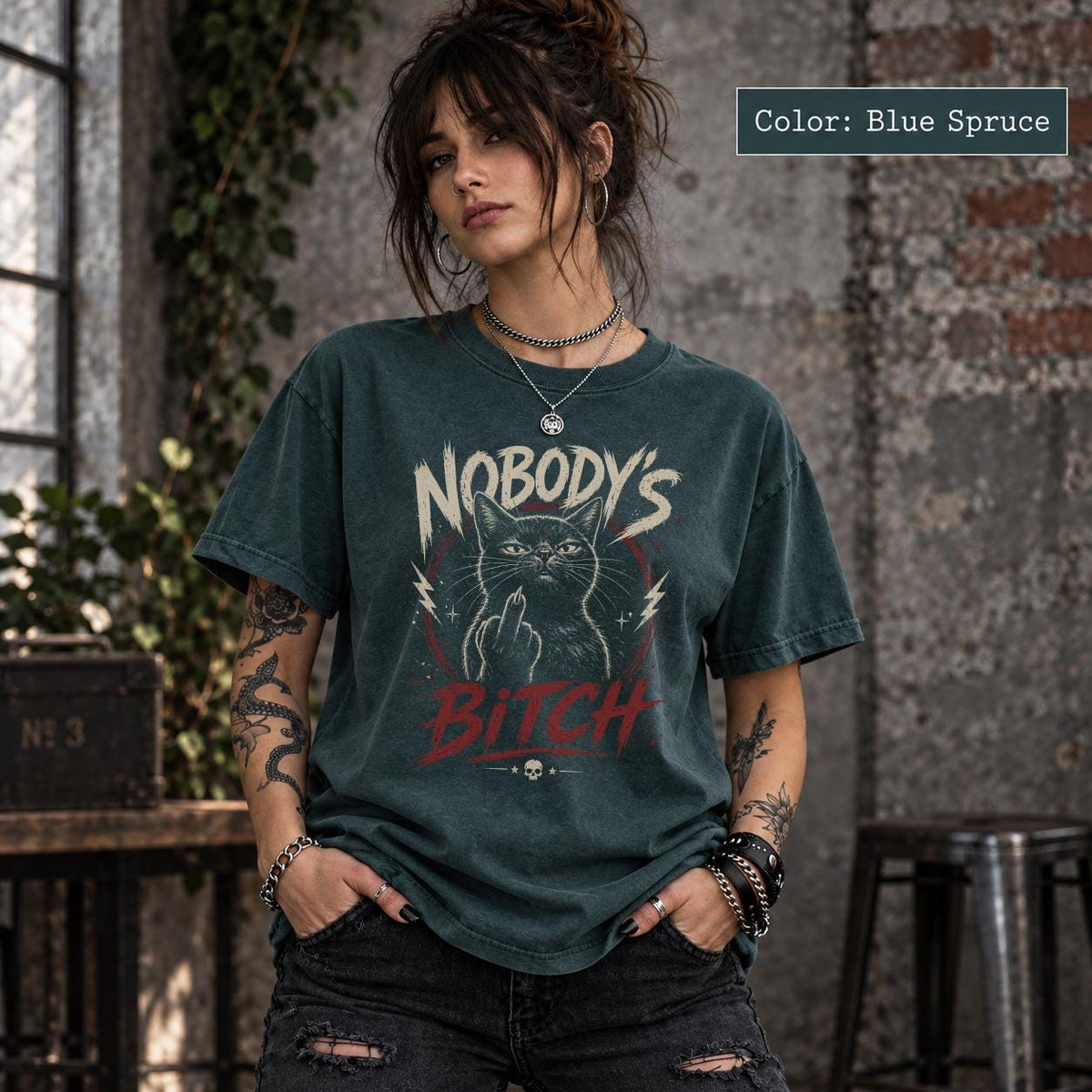 Blue Spruce Comfort Colors 1717 T-shirt with Nobody’s Bitch black cat artwork, vintage distressed details, and bold alternative graphic style.