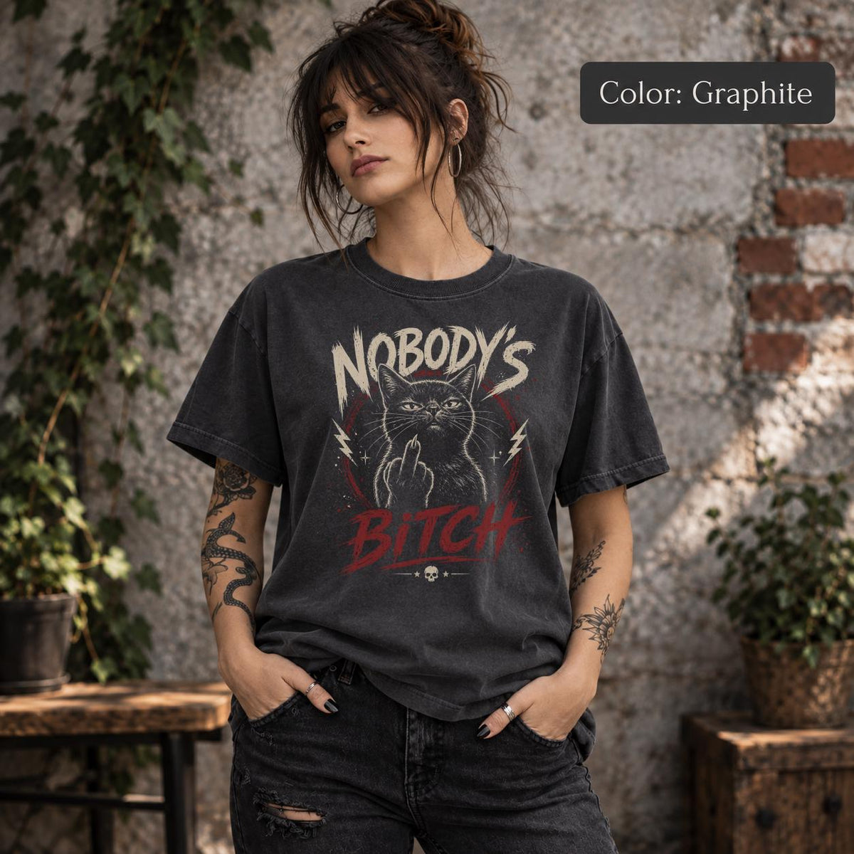 Graphite Comfort Colors 1717 shirt mockup featuring Nobody’s Bitch cat illustration, grunge lettering, red accents, and dark punk inspired design.