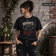 Black Comfort Colors 1717 T-shirt mockup with Nobody’s Bitch black cat graphic, grunge lettering, red accents, and alternative gothic style.