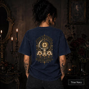 Female model wearing a True Navy Comfort Colors 1717 tee with a large gold celestial graphic reading The Universe Has My Back, featuring compass imagery, mountains, flowers, crystals, stars, and crescent moons.