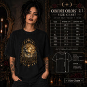 Size chart Female model wearing a black Comfort Colors 1717 shirt with a gold celestial Abundance design featuring sun and moon faces, crystals, stars, and moon phases.