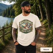 Natural shirt displaying the retro waterfowl design with a flying mallard, rustic badge lettering, and earthy hunting-inspired details.