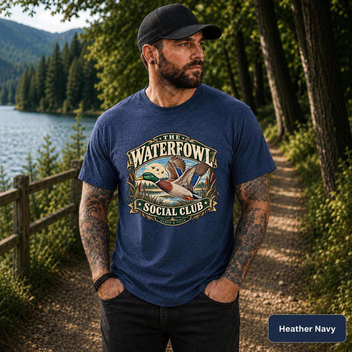 Heather Navy T-shirt featuring the rustic mallard design with lake, reeds, birds, and retro outdoor lettering.